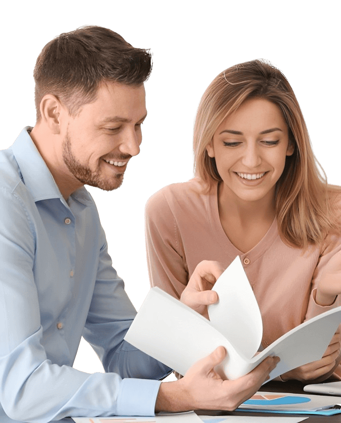 man and woman smiling looking at the paper